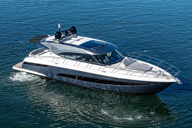 Slide: The Image of 2024 Riviera 5400 Sport Yacht cruising on open water. - 7
