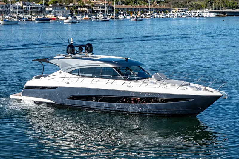 Slide: The Image of 2024 Riviera 5400 Sport Yacht cruising in a marina. - 8
