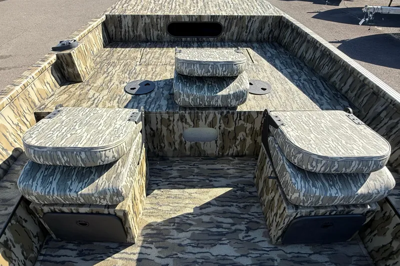 Slide: The Image of 2025 Smoker Craft Sportsman 1866 boat interior with camouflage seating and deck design. - 10