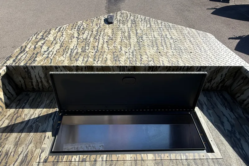 Slide: The Image of 2025 Smoker Craft Sportsman 1866 boat with open storage compartment, camouflage pattern. - 11