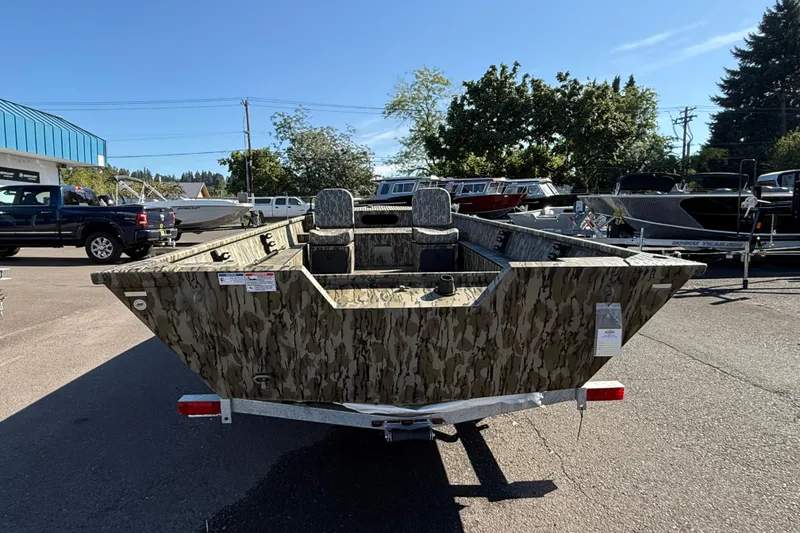 Slide: The Image of 2025 Smoker Craft Sportsman 1866 boat with camouflage design in a dealership lot. - 5