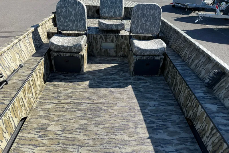 Slide: The Image of 2025 Smoker Craft Sportsman 1866 boat interior with camouflage seating and flooring. - 7