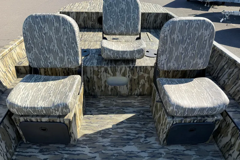 Slide: The Image of 2025 Smoker Craft Sportsman 1866 boat interior with camo-patterned seating. - 8