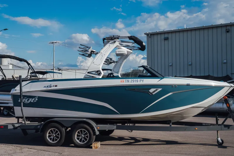 The Image of 2023 Tigé Z1 boat on trailer, parked outdoors under a blue sky. - 0
