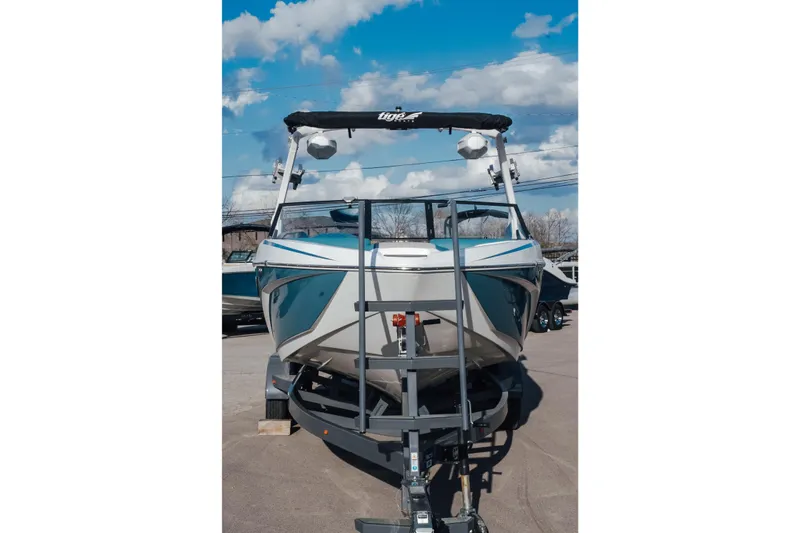 Slide: The Image of 2023 Tigé Z1 boat on trailer under blue sky. - 3