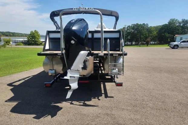 Slide: The Image of 2023 Viaggio Diamante U boat, rear view, parked on pavement with green landscape. - 1