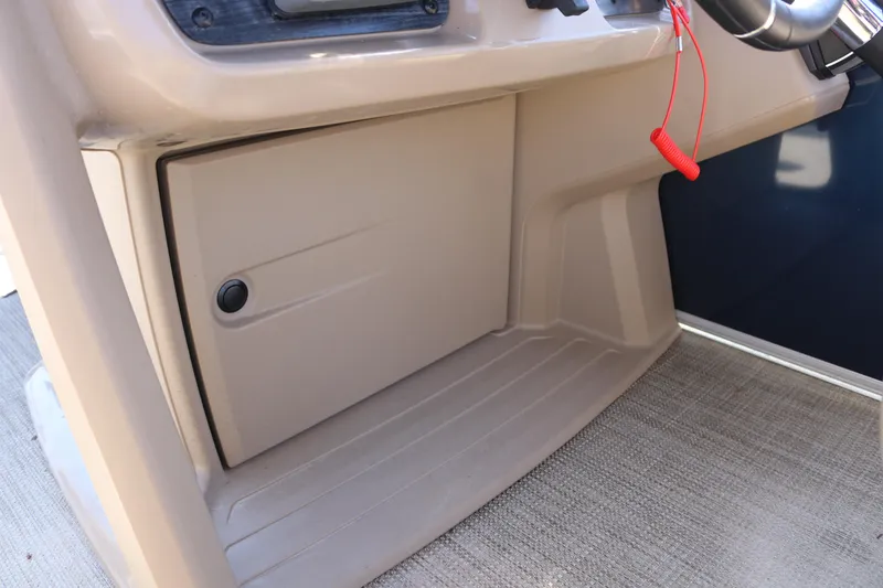 Slide: The Image of Interior view of 2025 Sun Chaser Vista Fish 18 boat console with storage compartment. - 13