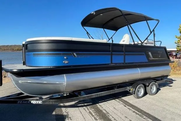Slide: The Image of 2023 Viaggio Diamante 23B pontoon boat on trailer, blue and black design, sunny day. - 14