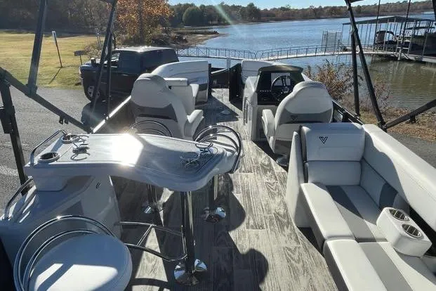 Slide: The Image of 2023 Viaggio Diamante 23B pontoon boat with luxurious seating and scenic lake view. - 3