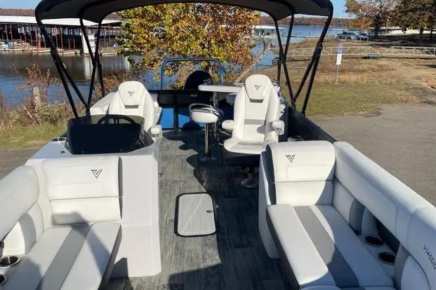 Slide: The Image of 2023 Viaggio Diamante 23B pontoon boat with spacious seating and canopy, docked by a scenic lake. - 8