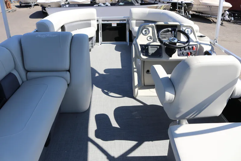 Slide: The Image of 2025 SunChaser Vista 20 Fish pontoon boat interior with plush seating and modern helm. - 13