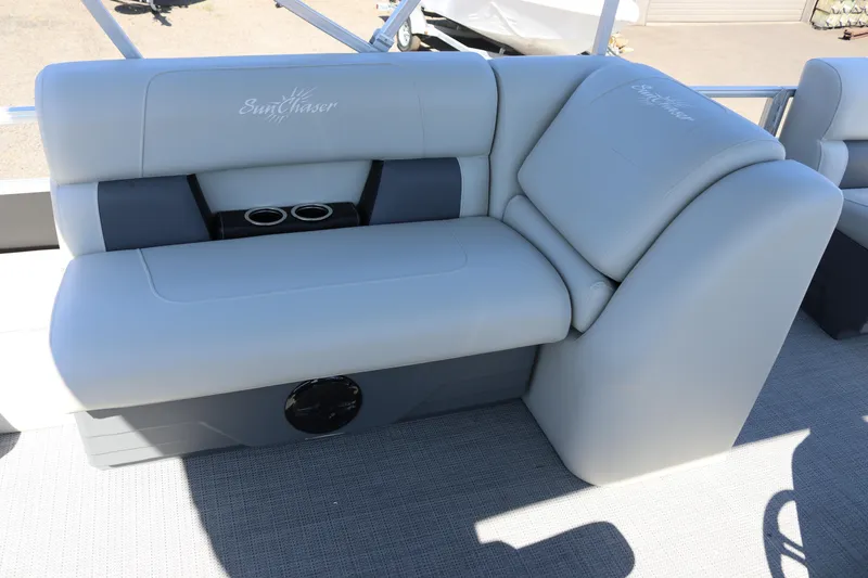 Slide: The Image of 2025 SunChaser Vista 20 Fish boat seating with cup holders, featuring light gray upholstery. - 22