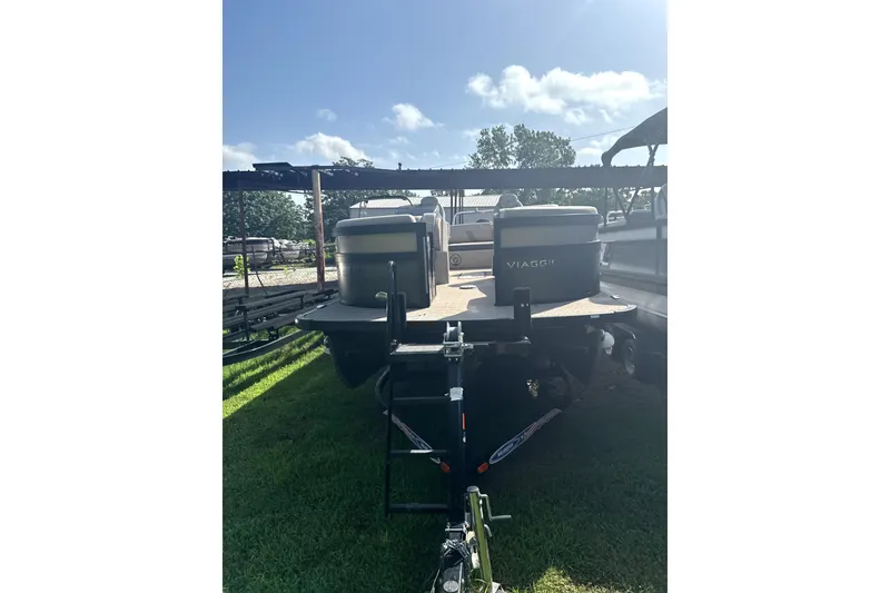 Slide: The Image of 2023 Viaggio Diamante S boat on trailer, parked on grass under clear sky. - 3