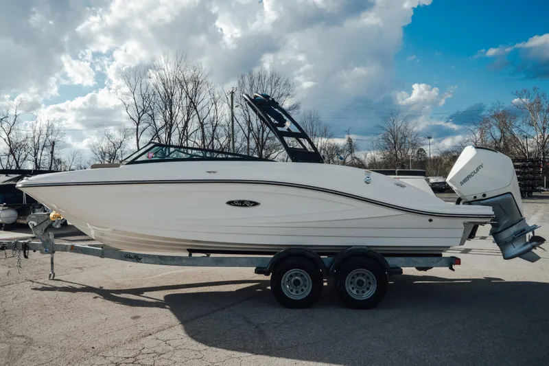 The Image of 2023 Sea Ray SPX 230 Outboard boat on trailer under cloudy sky. - 0