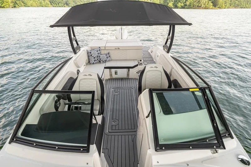 Slide: The Image of Manufacturer Provided Image: 2023 Sea Ray SPX 230 OB boat interior with seating and canopy on a lake. - 6