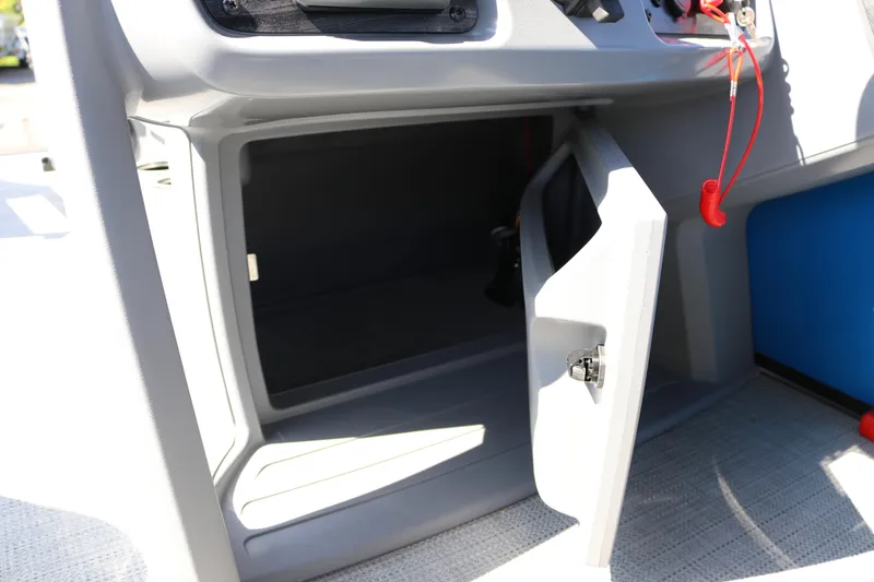 Slide: The Image of Open storage compartment on 2025 SunChaser Lucerne 20 LR DH boat dashboard. - 29