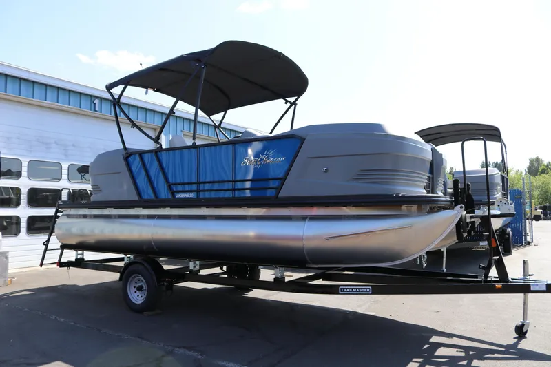 Slide: The Image of 2025 SunChaser Lucerne 20 LR DH pontoon boat on trailer, parked outdoors. - 5