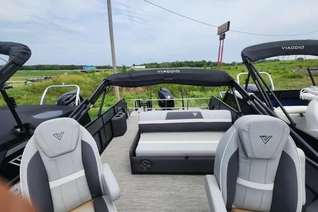 Slide: The Image of 2024 Viaggio Lago X22S pontoon boat with stylish seating and canopy in scenic outdoor setting. - 5