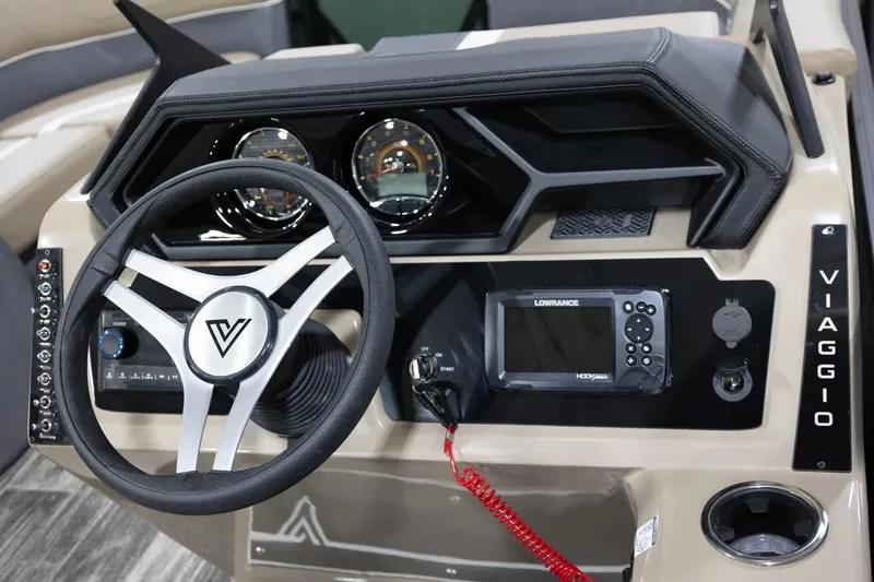 Slide: The Image of Manufacturer Provided Image: 2024 Viaggio Lago X-S boat dashboard with steering wheel, gauges, and Lowrance display. - 10