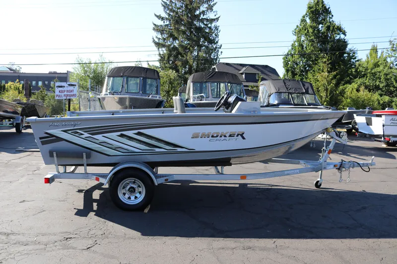 The Image of 2025 Smoker Craft Pro Lodge 160 boat on trailer, parked outdoors. - 0