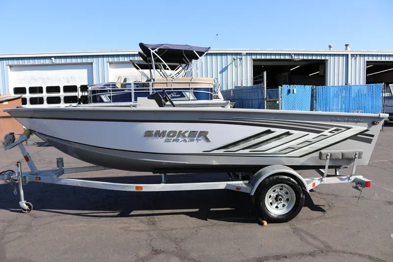 The Image of 2025 Smoker Craft Pro Lodge 160 boat on trailer, parked outdoors. - 1