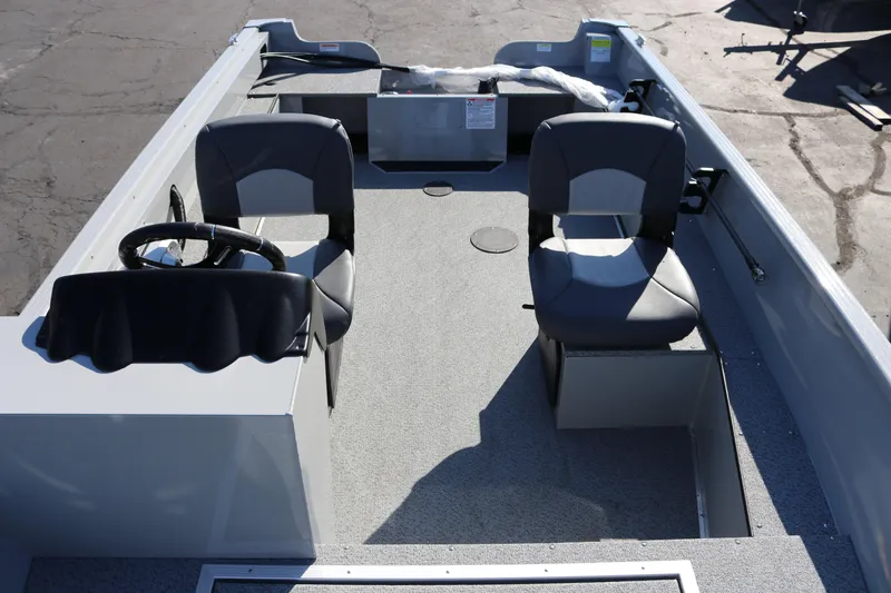 Slide: The Image of 2025 Smoker Craft Pro Lodge 160 boat interior with two seats and steering wheel. - 11