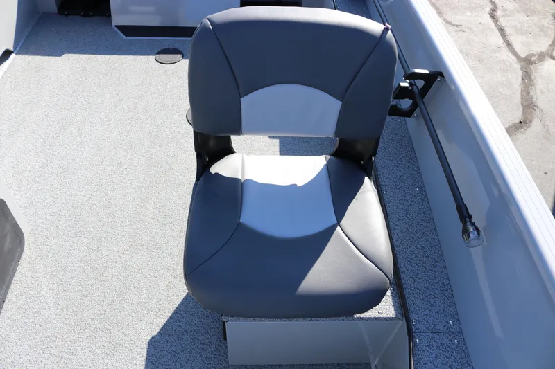 Slide: The Image of 2025 Smoker Craft Pro Lodge 160 boat seat, gray and white design, on textured flooring. - 13