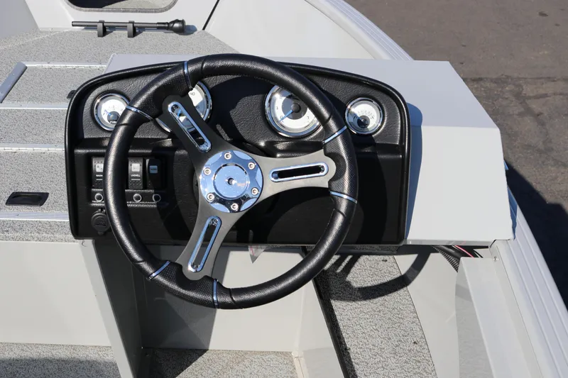 Slide: The Image of Steering console of 2025 Smoker Craft Pro Lodge 160 boat, featuring modern gauges and controls. - 7