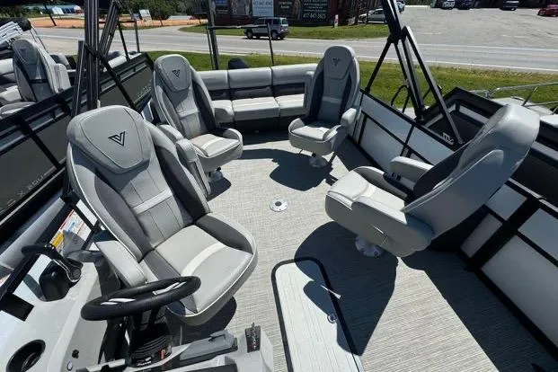 Slide: The Image of 2024 Viaggio Lago X22Q pontoon boat interior with modern seating and steering console. - 5