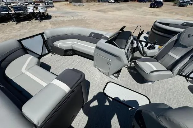 Slide: The Image of 2024 Viaggio Lago X22Q pontoon boat interior with gray seating and modern helm. - 7