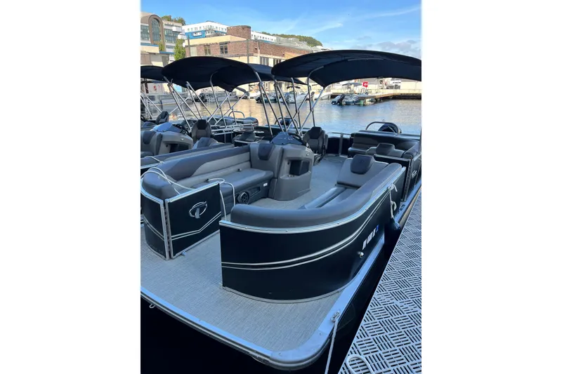 Slide: The Image of 2023 Tahoe Pontoon LTZ Cruise boat docked, featuring spacious seating and sleek design. - 5