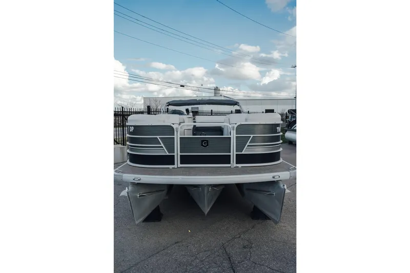 Slide: The Image of 2023 Godfrey Sweetwater 2286 C pontoon boat, front view, parked outdoors. - 2