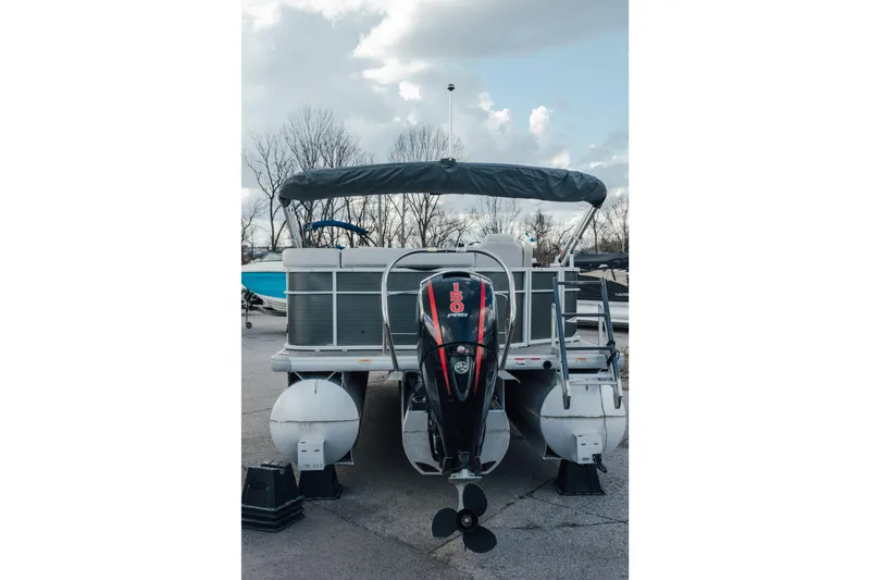 Slide: The Image of 2023 Godfrey Sweetwater 2286 C pontoon boat with outboard motor, parked outdoors. - 3