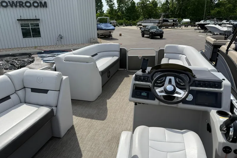 Slide: The Image of 2023 Godfrey Sweetwater 2286 C pontoon boat interior with plush seating and modern helm. - 6
