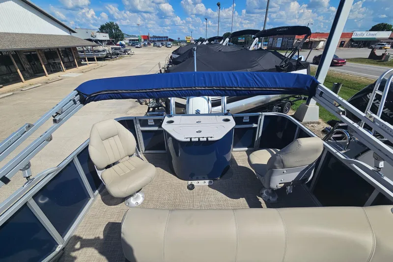Slide: The Image of 2024 Silver Wave 2410 SW3 RLP pontoon boat interior with seating and helm station. - 10