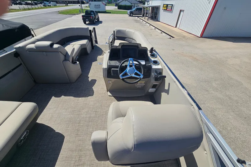 Slide: The Image of 2024 Silver Wave 2410 SW3 RLP pontoon boat interior with helm and seating. - 11