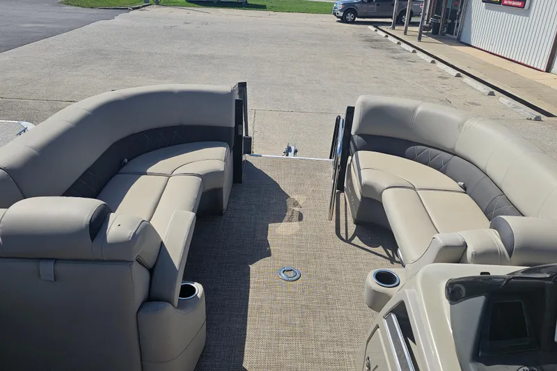 Slide: The Image of 2024 Silver Wave 2410 SW3 RLP pontoon boat interior with plush seating and cup holders. - 12