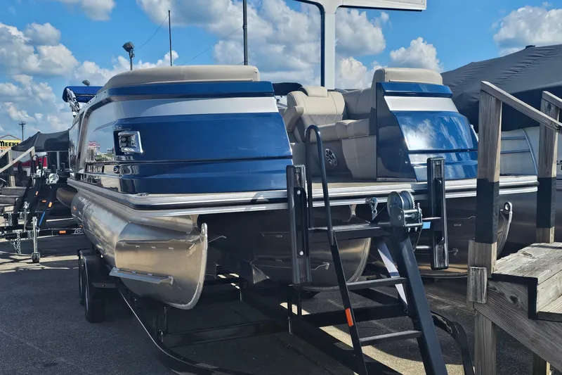 Slide: The Image of 2024 Silver Wave 2410 SW3 RLP pontoon boat displayed outdoors under a blue sky. - 14