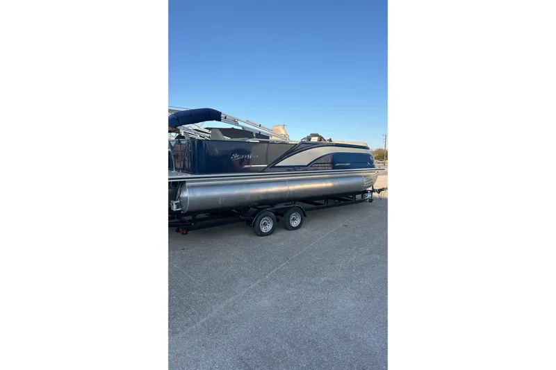 Slide: The Image of 2024 Silver Wave 2410 SW3 RLP pontoon boat on trailer, parked outdoors. - 6