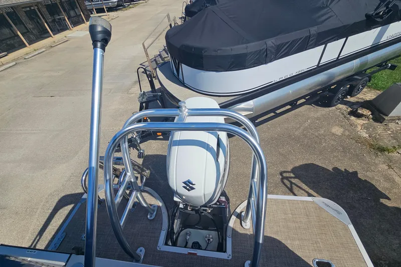 Slide: The Image of 2024 Silver Wave 2410 SW3 RLP boat with Suzuki outboard motor, docked on trailer. - 7