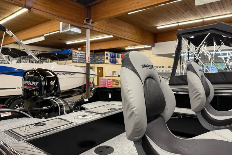 Slide: The Image of 2025 Smoker Craft Excursion 166 SC Pro boat interior with Mercury engine in showroom. - 10