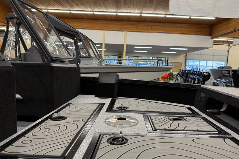 Slide: The Image of 2025 Smoker Craft Excursion 166 SC Pro boat interior with sleek design and storage compartments. - 11