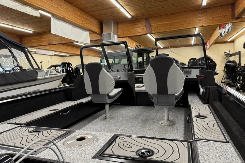 Slide: The Image of 2025 Smoker Craft Excursion 166 SC Pro boat interior with seating and storage compartments. - 8