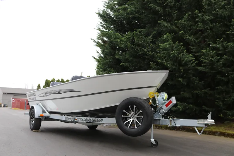 Slide: The Image of 2024 Alumaweld Free Drifter 20 boat on trailer, parked near trees. - 5