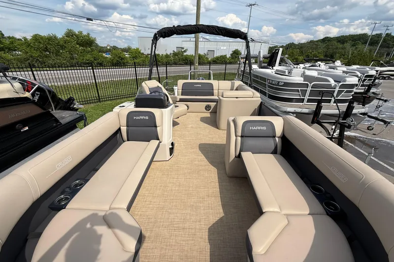 Slide: The Image of 2024 Harris Cruiser 230 pontoon boat with spacious seating and modern design. - 10