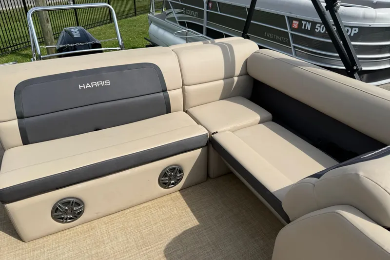 Slide: The Image of 2024 Harris Cruiser 230 boat interior with beige seating and built-in speakers. - 8
