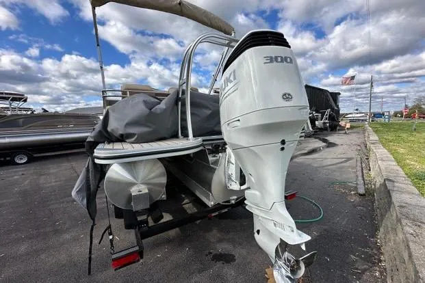 Slide: The Image of 2024 Silver Wave 2610 SW7 JS boat with powerful 300 HP engine, parked outdoors. - 1