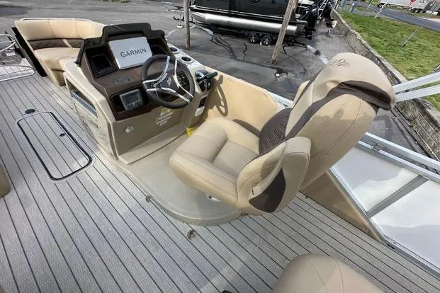 Slide: The Image of 2024 Silver Wave 2610 SW7 JS boat interior with Garmin navigation system and plush seating. - 14