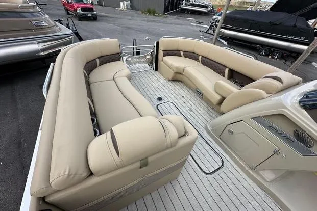 Slide: The Image of 2024 Silver Wave 2610 SW7 JS pontoon boat with spacious beige seating and modern design. - 16