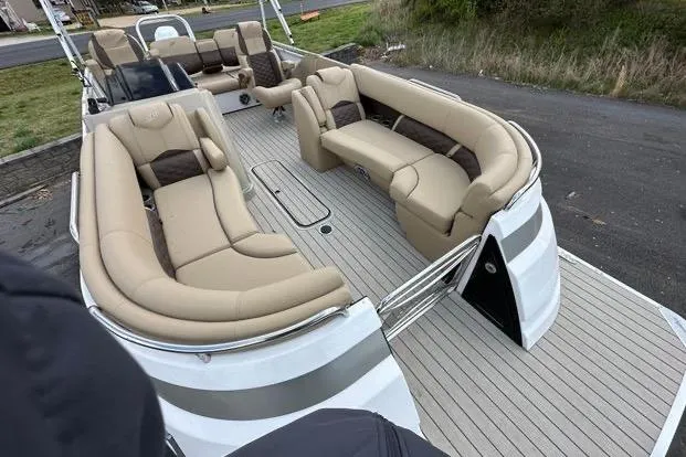 Slide: The Image of 2024 Silver Wave 2610 SW7 JS pontoon boat with spacious beige seating and sleek design. - 2
